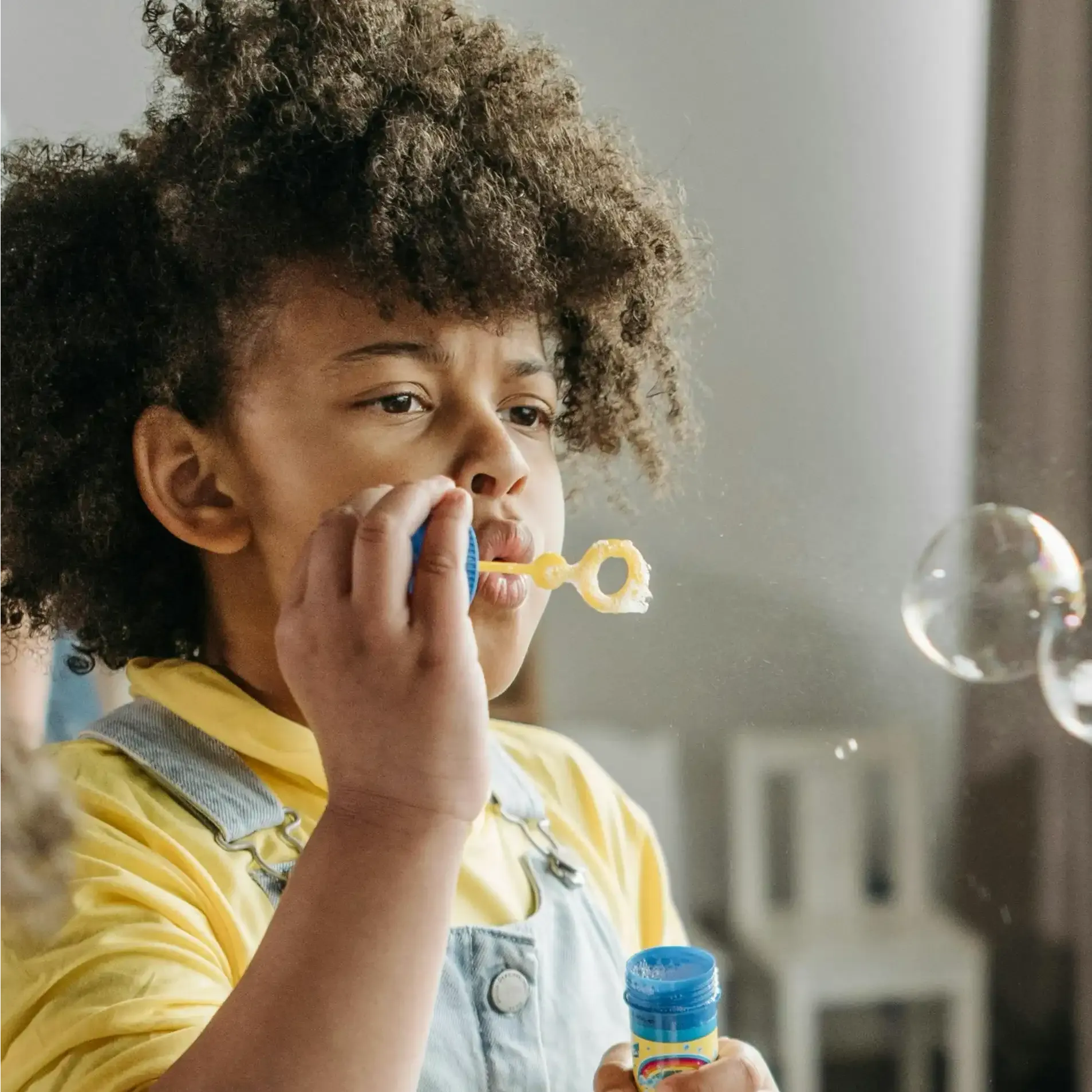 Child blowing bubbles